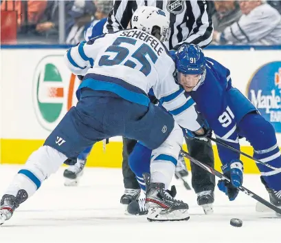  ?? RICK MADONIK TORONTO STAR ?? John Tavares had a rough night against Mark Scheifele and the Winnipeg Jets, with a couple of errors that led to goals Thursday.