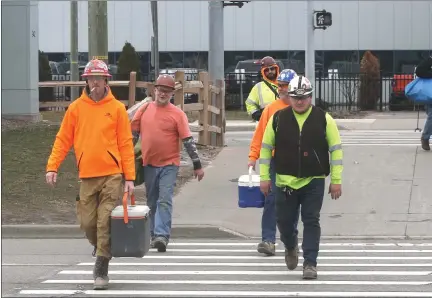  ?? PHOTOS BY DAVID ANGELL — FOR THE MACOMB DAILY ?? Hourly workers leave the Warren Truck Assembly Plant Wednesday afternoon after being sent home by FCA.