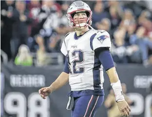  ?? TROY TAORMINA • USA TODAY SPORTS ?? New England Patriots quarterbac­k Tom Brady walks off the field after a play during the third quarter against the Houston Texans on Sunday night at NRG Stadium.