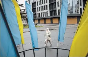  ?? DANIEL COLE THE ASSOCIATED PRESS ?? A woman walks in a street in Kryvyi Rih, Ukraine, Sunday.