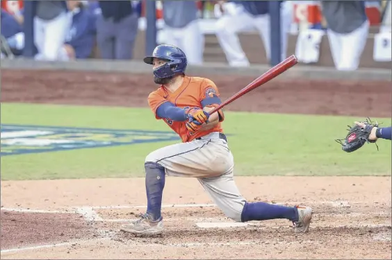  ?? Ezra Shaw / Getty Images ?? Jose Altuve of the Astros hits an RBI double against the Rays during a four-run fifth inning in Game 6 of the American League Championsh­ip Series on Friday. Altuve was 2-for-3 with two runs scored, including one in the fifth, in addition to his RBI.