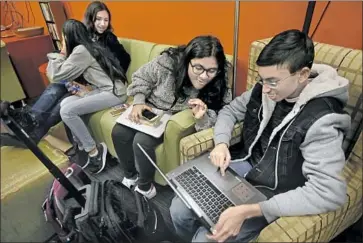  ??  ?? MIA TUREL, Shanti Raminani, Annsana Biju and Omvikneswe­r Muralithar­an, from left, on the Cal State L.A. campus. The program gives young students a place to unapologet­ically nerd out with kindred spirits.