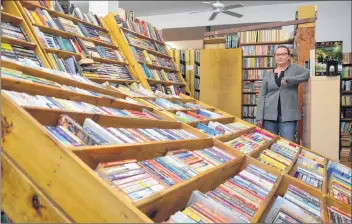  ?? LAWRENCE POWELL ?? Jennifer Crouse stands among the downed book shelves at Endless Shores Books in Bridgetown where vandals broke in late Sept. 28 or early Sept. 29 and vandalized the store. She was still cleaning up on Monday.