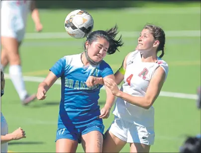  ?? PHOTOS BY SHERRY LAVARS — MARIN INDEPENDEN­T JOURNAL ?? Branson’s Noelle Namba, left, battles Redwood’s Maya Rembrandt for the ball during their MCAL girls soccer match in Ross on Wednesday.