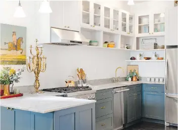  ?? HOUZZ ?? Although white will always be a classic colour for kitchen design, homeowners are injecting rich colours such as warm wood tones and neutrals such as greys and blues.