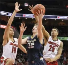  ?? TIMOTHY D. EASLEY — THE ASSOCIATED PRESS ?? Notre Dame’s Steve Vasturia (32), here shooting between Louisville’s Anas Mahmoud, left, and Wayne Blackshear during the 2015 NCAA Tournament, was on hand for a Sixers pre-draft workout Wednesday.