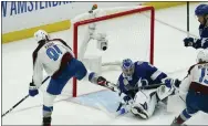  ?? JOHN BAZEMORE - THE ASSOCIATED PRESS ?? Colorado Avalanche center Nazem Kadri shoots the puck into the top of the goal past Tampa Bay Lightning goaltender Andrei Vasilevski­y for a goal during overtime of Game 4of the Stanley Cup Finals on Wednesday.