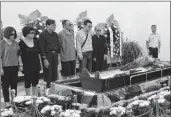  ??  ?? Liu Xiaobo's wife Liu Xia and family members standing next to Xiaobo's body at the funeral on Saturday.