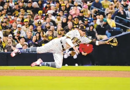  ?? NELVIN C. CEPEDA U-T ?? Padres third baseman Manny Machado won two Gold Gloves in the AL with the Orioles, but Cardinals’ Nolan Arrenado stands in his way in the NL.