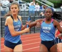  ?? DIGITAL FIRST MEDIA FILE PHOTO ?? Mikaela Vlasic takes the baton from Uche Nwogwugwu to begin the anchor leg of the 4x800 meter relay.