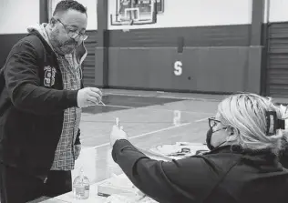  ?? Photos by Jerry Lara / Staff photograph­er ?? Somerset High School coach Leonard Jimenez gets a COVID test at the school’s gym. Somerset ISD requires all students to take rapid tests Mondays, Superinten­dent Saul Hinojosa said.