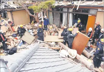  ?? — US Air Force photo ?? Los Angeles County Fire Urban Search and Rescue Team members help search through rubble in earthquake stricken areas of Japan with their Japanese counterpar­ts in 2015.