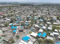  ?? AP PHOTO/DENNIS M. RIVERA ?? This year-after photo of San Juan, Puerto Rico, illustrate­s that thousands of people across the island are still living in damaged homes, protected by blue plastic tarps, after Hurricane Maria devastated the island.