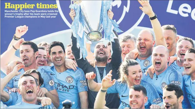  ??  ?? Manchester City boss Pep Guardiola holds the winner’s trophy after his team were crowned Premier League champions in May last year