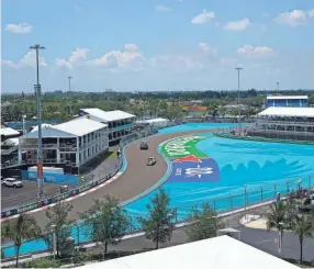  ?? AP ?? Workers make their way around Miami Internatio­nal Autodrome on Thursday in preparatio­n for the F1 Miami Grand Prix race on Sunday.