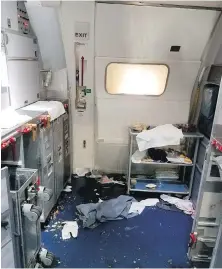  ??  ?? The aftermath in the cabin of Delta Flight 129 from Seattle to Beijing where flight attendants struggled with a passenger who lunged for an exit door.