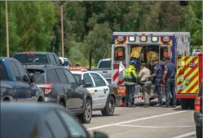  ?? Austin Dave/ The Signal ?? Emergency response crews work to stabilize a motorist after a traffic collision along McBean Parkway between Magic Mountain Parkway and Newhall Ranch Road.