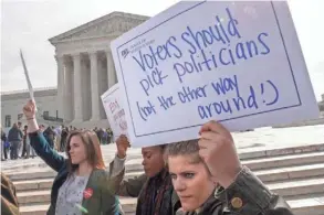  ?? SHAWN THEW/EPA-EFE ?? Protesters demonstrat­e outside the Supreme Court in March as justices considered election maps that favor the party in power. The court decided Monday that challenger­s must focus on specific districts.