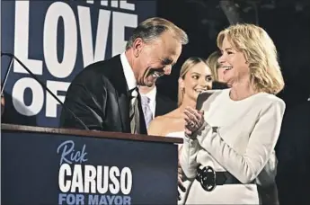  ?? Wally Skalij Los Angeles Times ?? RICK CARUSO and his wife, Tina, celebrate with supporters at the Grove on election night. “This is a great night because so many people have gone to the voting booth and they sent a message,” Caruso said.