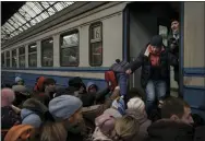  ?? FELIPE DANA — THE ASSOCIATED PRESS ?? Passengers rush to board a train leaving to Slovakia from the Lviv railway station, in Lviv, west Ukraine, on Wednesday. Russian forces have escalated their attacks on crowded cities.