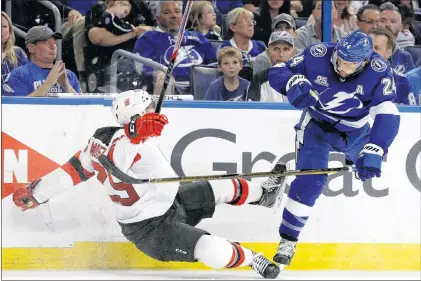  ?? AP PHOTO ?? Tampa Bay Lightning right wing Ryan Callahan (24) sends New Jersey Devils defenseman Mirco Mueller flying with a check during the second period of Game 5 of an NHL first-round playoff series Saturday in Tampa, Fla.