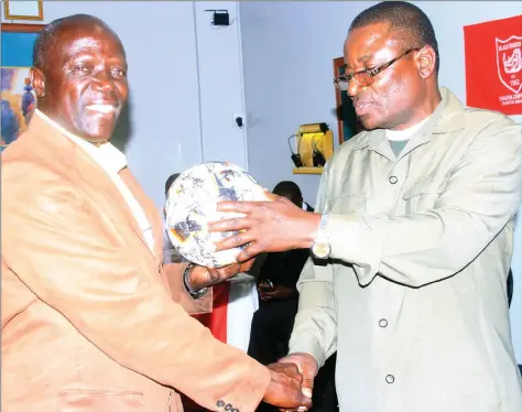  ??  ?? LAST SUPPER . . . Stanford “Stix’’ Mtizwa (left) presides over his last function as Black Rhinos coach by handing an autographe­d ball to the club’s former chairman Justin Mujaji who was the guest of honour at the army side’s awards ceremony in Harare...