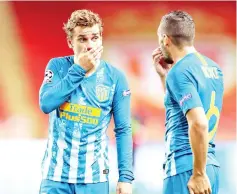  ??  ?? Griezmann (left) and Atletico Madrid’s Spanish midfielder Koke speak together during the UEFA Champions League first round football match between AS Monaco and Atletico Madrid at the Stade Louis II, in Monaco. — AFP photo