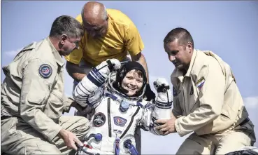  ?? | AP African News Agency (ANA) ?? A RUSSIAN space agency rescue team helps US astronaut Anne McClain out of the capsule shortly after the landing of the Russian Soyuz MS-11 space capsule, about 150km south-east of Zhezkazgan, Kazakhstan, yesterday. A Soyuz space capsule with McClain, Russian cosmonaut Оleg Kononenko and Canadian Space Agency astronaut David Saint-Jacques, returning from a mission to the Internatio­nal Space Station, landed safely on the steppes of Kazakhstan.