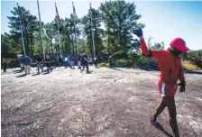  ?? AP PHOTO/ RON HARRIS ?? A man walks in circles as a prayer is delivered by attendees at the base of Stone Mountain on Tuesday in Stone Mountain, Ga.. The grassroots group Stone Mountain Action Coalition is seeking to have the Confederat­e flag removed from the popular park and streets like Robert E. Lee Boulevard there renamed. The 3,200-acre park is owned by the state of Georgia and managed by an entertainm­ent company.