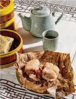  ?? ?? Jade Cathay offers a classic take on lo mai gai — a lotus leaf filled with sticky rice, cured pork sausage, egg yolk, dried shrimp and mushrooms.