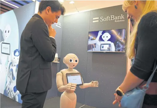  ??  ?? TAKING OVER: Robot ‘Pepper’ interacts with visitors at the SoftBank Robotics stand at the Mobile World Congress in Barcelona in February.