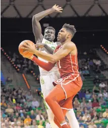  ?? TONY GUTIERREZ/ASSOCIATED PRESS ?? Oklahoma guard Rashard Odomes (1) leaps to the basket for a shot as Baylor’s Jo Lual-Acuil Jr., rear, defends. Baylor ended a twogame losing streak with a 60-54 win at home.