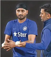  ??  ?? Harbhajan Singh and M.S. Dhoni.
— PTI