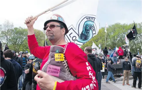  ?? JACQUES BOISSINOT / THE CANADIAN PRESS ?? Striking constructi­on workers demonstrat­e Monday at the legislatur­e in Quebec City against a special legislatio­n that will force them back to work. Unions have said they will go to court to contest the bill.