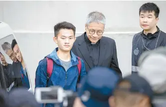  ?? EPA-Yonhap ?? Chan Tong-kai, left, a murder suspect wanted by Taiwan, accompanie­d by Anglican pastor Peter Koon, right, walks out of the Pik Uk Correction­al Institutio­n in Hong Kong, Wednesday.