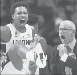  ?? CLOE POISSON/CPOISSON@COURANT.COM ?? UConn Huskies guard Jalen Adams (4) and coach Dan Hurley react to a threepoint­er by guard Alterique Gilbert (3) in the first half of their season opener against Morehead State.