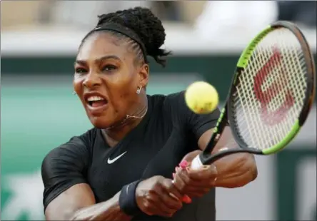  ?? CHRISTOPHE ENA — THE ASSOCIATED PRESS ?? Serena Williams of the U.S. returns a shot against Germany’s Julia Georges during their third round match of the French Open tennis tournament at the Roland Garros stadium in Paris, France, Saturday.