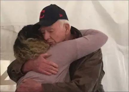  ?? ANDREW CASS — THE NEWS-HERALD ?? Homeowner Kirsten hugs project manager Bill O’Donnell at the Lake-Geauga Habitat for Humanity dedication of her new Mentor-on-theLake home.