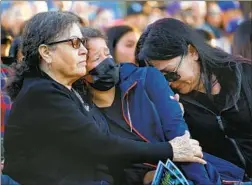  ?? ?? JAYDE SANTANA, 9, center, daughter of Officer Joseph Santana, is comforted by great-grandmothe­r Sara Pinedo and grandmothe­r Lupe Pinedo.