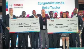  ??  ?? The Hello Tractor and BuuPass teams accept their prize money from Bosch representa­tives after a fierce competitio­n in which 222 entries were whittled down to 11 finalists.