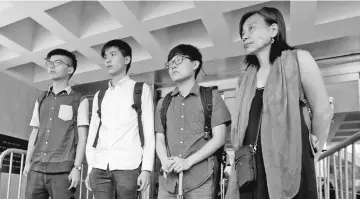  ??  ?? Student leaders during ‘Occupy Central’, Joshua Wong (left) and Lester Shum (second left), and two other protesters walk out of the High Court after pleading quilty in Hong Kong, China. — Reuters photo