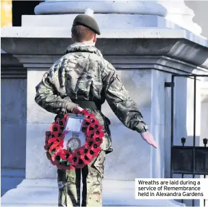  ??  ?? Wreaths are laid during a service of Remembranc­e held in Alexandra Gardens