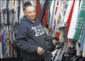  ?? Sue Ogrocki The Associated Press ?? Angela Nelson looks through an apparel closet at the Oklahoma City Day Shelter in Oklahoma City. Nelson had three children when she did her first 18-month stint in an Oklahoma prison at age 24 for writing a bogus check.