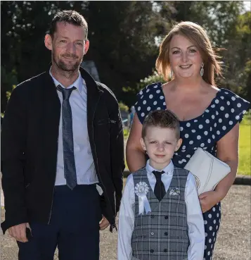  ??  ?? Moneystown NS pupil Devon Davis on the occasion of his First Holy Communion, with his parents Maureen and Damien.