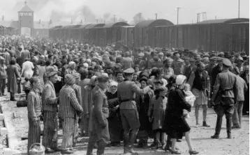  ??  ?? NAZI EVIL: Hungarian Jews on the Judenrampe (Jewish ramp) after disembarki­ng from the transport trains coming from Budapest. They were sent “Rechts!” (to the right) for the labour detail, or “Links!” (left) for the gas chambers. Photo from the Auschwitz Album, May 1944