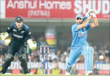  ?? AFP ?? India captain Mahendra Singh Dhoni plays a shot as New Zealand wicketkeep­er BJ Watling looks on during the fourth one-day internatio­nal of the series in Ranchi on October 26.