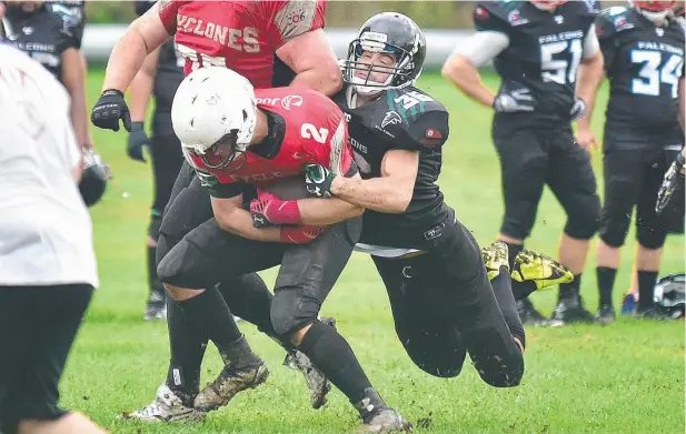  ??  ?? GAME ON: Cairns Falcons’ David Nash tackles Townsville Cyclones’ Liam LaBlanche in the gridiron season opener.