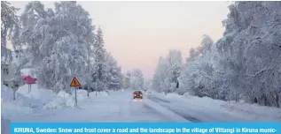  ?? — AFP ?? KIRUNA, Sweden: Snow and frost cover a road and the landscape in the village of Vittangi in Kiruna municipali­ty in the north of Sweden.