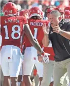 ?? WILLIAM BRETZGER/DELAWARE NEWS JOURNAL ?? Rutgers coach Greg Schiano greets his offense after a touchdown in the second quarter of Delaware’s 45-13 loss at SHI Stadium in Piscataway, N.J., on Sept. 18.