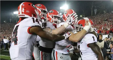  ?? Curtis Compton / AJC via AP ?? Georgia players celebrate with Sony Michel after his touchdown in double overtime in the Rose Bowl against Oklahoma on Monday in Pasadena, Calif.